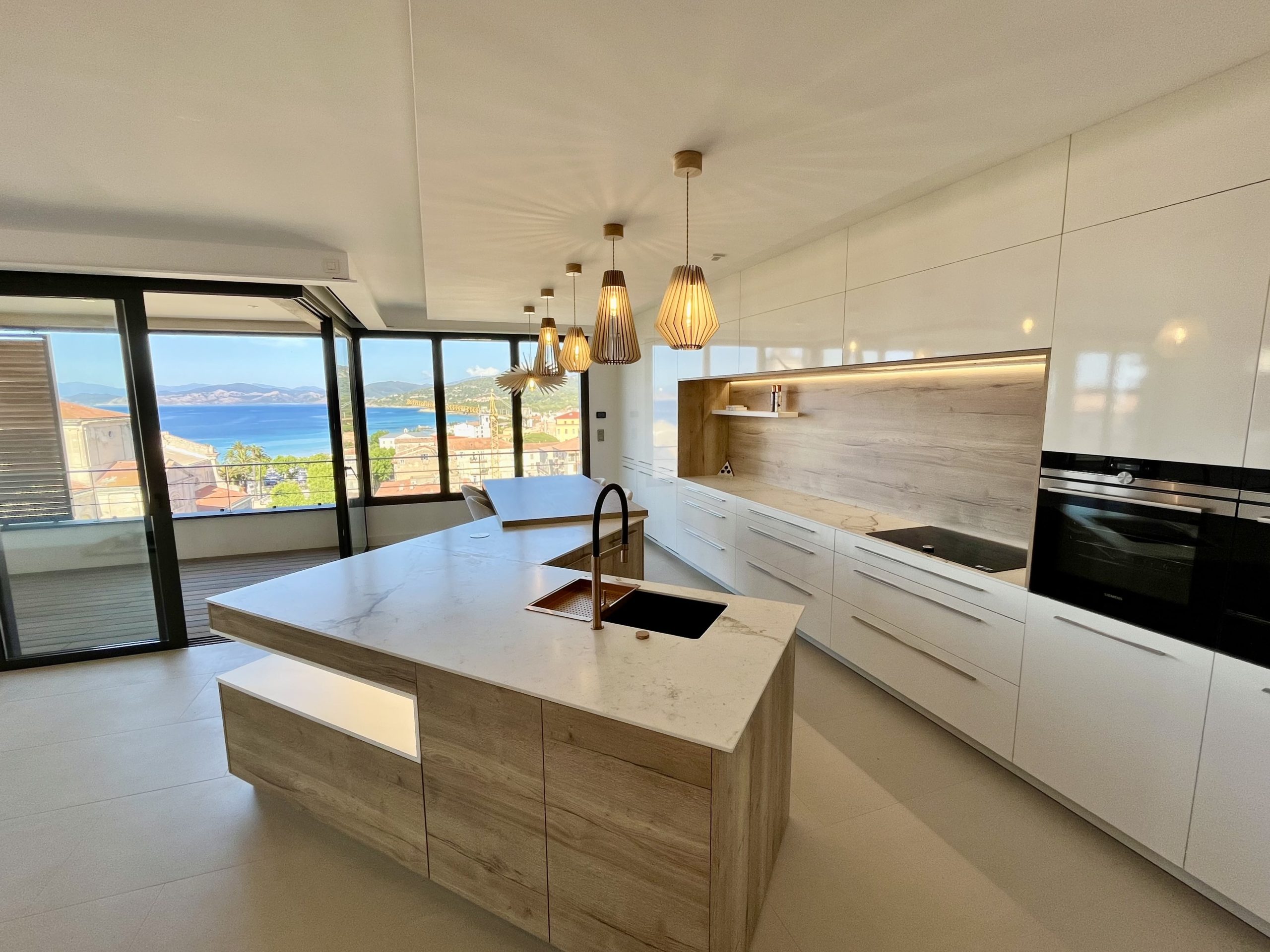 Cuisine contemporaine avec îlot en marbre vue mer